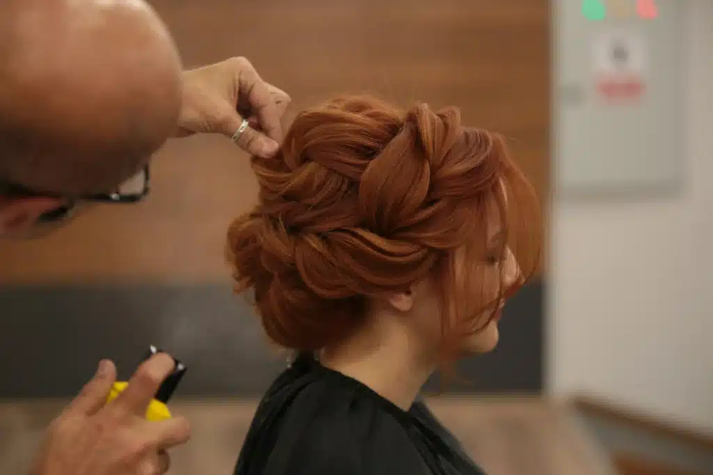 Woman recieving an Updo haircut in London