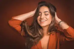 Woman touching hair after recieving a Keratin Treatment in London