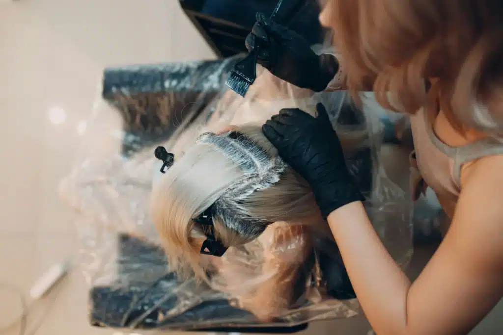 Woman having a regrowth tint treatment in London